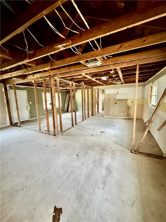 Miscellaneous room with unfinished concrete floors