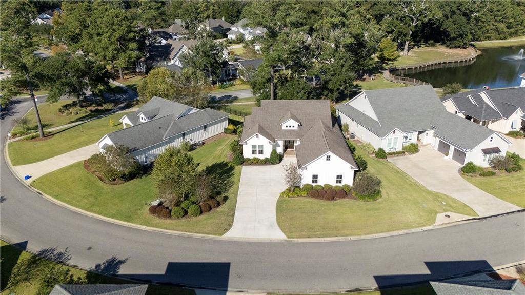 Aerial view of property and surrounding area with nearby suburban area