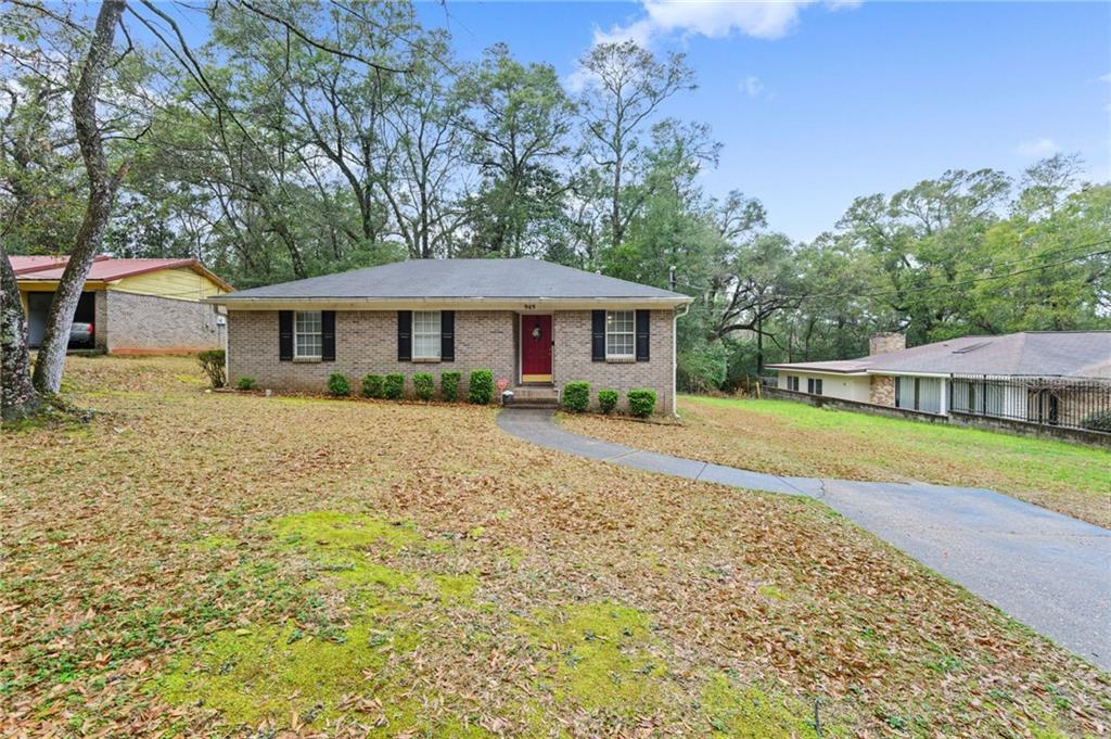 Ranch-style house with a front lawn and brick siding