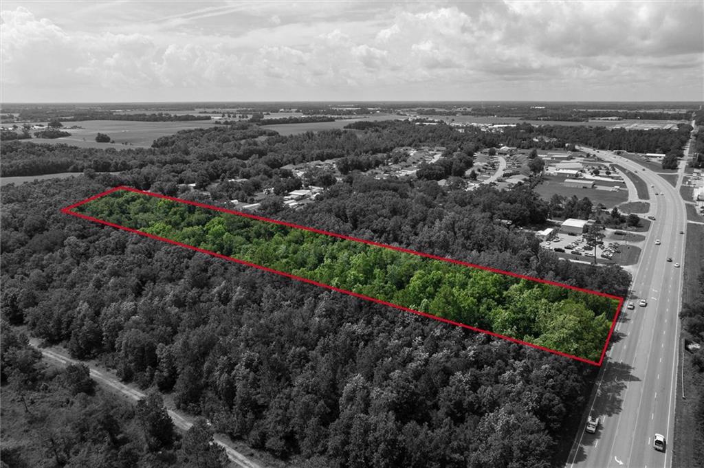 Aerial overview of property's location with a forest and property parcel outlined