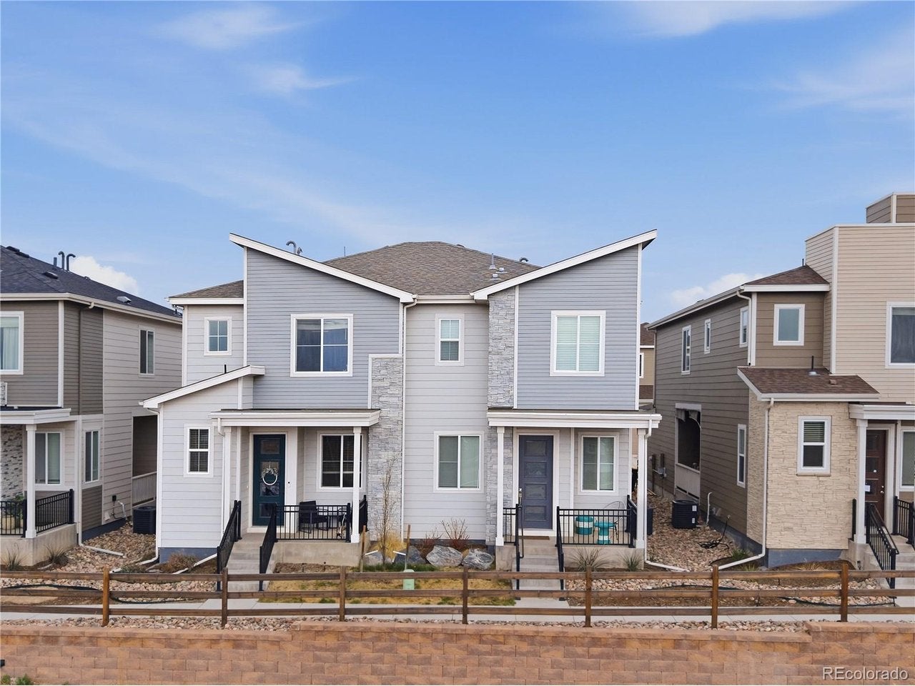 Exterior Front - Attractive modern townhome exterior with contemporary architectural lines, stone accents, and welcoming covered front porch.