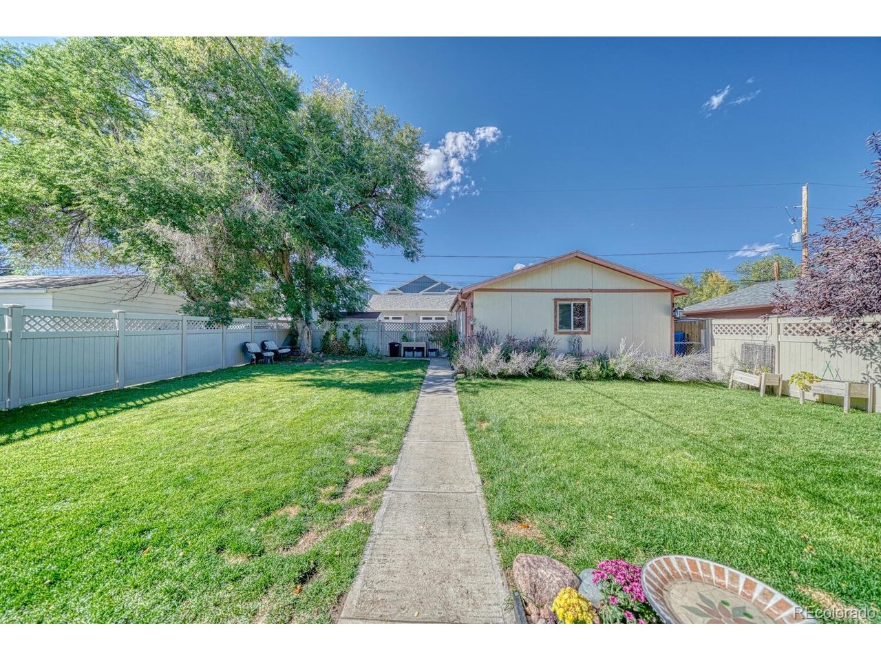 Fully fenced back yard with sprinkler systems.