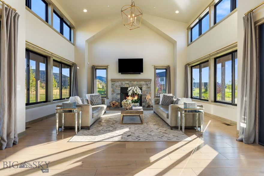 Inspired by the timeless coastal elegance of Martha’s Vineyard, this custom 6,146 sq ft home in the coveted Home 40 community blends refined design with Montana’s mountain backdrop. Set on 1.28 acres that back to open green space and trail systems, every element of this residence was thoughtfully curated by its owner.

The main level offers an open-concept design with vaulted ceilings, engineered hardwood floors (no carpet throughout the home), and expansive Anderson windows that frame sweeping meadow and mountain views. A chef’s kitchen features a Sub-Zero refrigerator/freezer, Café cooktop, double ovens, farmhouse sink, and walk-in pantry. The great room centers on a wood-burning fireplace and opens to a covered patio and wraparound porch with irrigated flower pots for effortless seasonal color.

The primary suite is a true retreat, capturing sunrises and mountain views from the comfort of your own bed. The spa-like bathroom includes dual shower heads, a soaking tub, and a fully customized walk-in closet. Upstairs you’ll find three bedrooms (each with blackout blinds), two full baths, a loft, and a secondary living room.

The basement is partially finished, offering a completed full bathroom, a framed bedroom, and a large open space ready for fitness, recreation, or guest quarters.

Mechanical highlights include two furnaces, two A/C units, two 50-gallon hot water heaters, an owned water softener, a Vivint smart security system, DogWatch invisible fencing, and full landscaping with underground sprinklers.

The Home 40 community provides a clubhouse, pool, fitness center, ponds, and an extensive trail network. HOA dues ($715/quarter) cover snow removal, trail and park maintenance, and water/sewer.

This property offers a rare combination of luxury finishes, functional design, and a lifestyle rooted in both comfort and Montana beauty.
