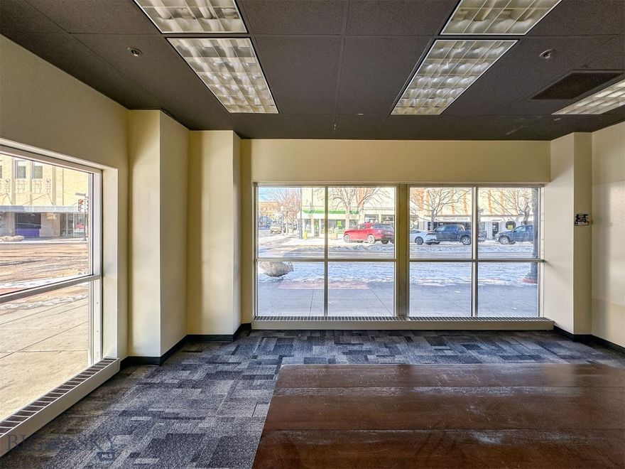 If you are looking for high visibility, and traffic counts in the downtown Great Falls core, this is IT! The modern AND historic blding offers 35,000 sqft of floor space on the ground floor that captures Central Ave and 4th St North attention with its long expanse of big windows. Previously, the versatile space was leased to a call center, but would be ideal for retail, bar/restaurant/brewery, law firm, medical services, government, general offices, and so much more. Currently, there is a lobby, reception, seating areas, conference rooms, a full kitchen, dining space, bathrooms, and loading dock. Also, enjoy an extensive fiber optic system and uninterrupted power with a back-up generator. Previous tenant made over a million dollars in tenant improvements. Landlord can rebuild to suit and/or divide the space, if you do not need the full 35,000 sq feet. Covered and open parking available, but not included in lease price. Air cooling system in place. Dozens of office chairs, cubicles, televisions, kitchen equipment, other furnishings, shelving, monitor holders are available, but not included in the lease. Carpet and laminate are current floor coverings. Women's bathroom is handicapped accessible and has 10 stalls and 6 sinks. Men's is handicap accessible with 2 stalls, 3 urinals, and 3 sinks. Opening up the mezzanine would create 19 foot ceiling heights. Building formerly dubbed the historic Strain building and was once Sears. Building currently home to an event center, the bar Elevation, golf simulators, counselors, attorneys, and more. Property manager on site. Loading docks are currently shared, but landlord could convert to separate and private, if new tenant needs. Building is NOT FOR SALE. This is commercial lease only. Also, see additional space, for lease, on separate floors, under separate listing.