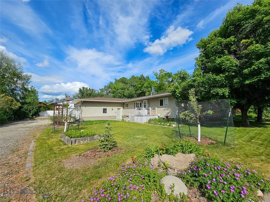 Tucked into one of the best locations in Big Timber, this home offers both privacy and convenience—just one block from the city park and close enough to hear the soothing sounds of the Boulder River. The large lot features mature landscaping and a charming enclosed gazebo, perfect for entertaining, hobbies, or quiet retreat.

Inside, the home boasts a spacious kitchen with abundant counter space and storage, highlighted by a bay window over the sink that looks out onto the peaceful backyard. The main floor includes three bedrooms, two full baths, and a dedicated laundry room. Natural light fills the dining area, with windows and sliding glass doors leading to a backyard patio—an ideal setup for indoor-outdoor living.

An attached two-car garage with extra-tall doors offers room for vehicles and gear, completing this rare find in a sought-after neighborhood.
