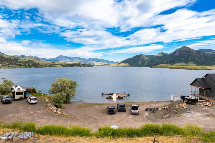 Amazing piece of land at Holter Lake! This rare property with lake access is BUILD READY with over $250,000 of infrastructure completed. Wells completed! Septic systems completed! Electricity to the sites completed! This property features private a boat launch, private beach, and is secured in the Holter Heights development. Come and build your dream home with seller financing options available. Call to schedule a tour and ask about these great financing options or your real estate professional. Building in photos is an example of what could be built and is not for sale.