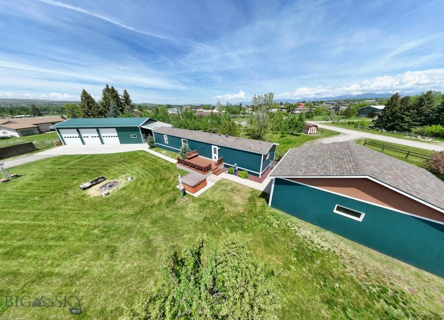 Perfectly positioned between Bozeman and Big Sky, this remarkable property is brimming with potential! The 1,260-square-foot home boasts three spacious bedrooms and two full bathrooms, featuring fresh carpeting in some areas and a spacious primary suite complete with new laminate tile floors in the bathroom. Other recent updates include plumbing fixtures, vinyl blinds, a brand-new refrigerator, and fresh interior and exterior paint, complemented by an inviting new front door. Both the front and back large decks provide exceptional spaces for outdoor relaxation and stunning mountain views. The expansive 0.7-acre lot includes a hot tub, fire pit, and thoughtfully landscaped areas, complete with fencing to keep your four-legged friends safe. The oversized detached garage (24x28) offers ample room for your trucks, toys, storage, and hobbies. However, the true crown jewel of this property may be the large shop built in 2014. Spanning an impressive 30x60, it’s a dream come true for any handyman, featuring three 10x10 overhead doors, radiant overhead heating, 220 outlets, a 30 amp outlet, LED lighting, a separately sealed “spray room” with sealed lights and an exhaust fan, a 10,000 lb. BendPak asymmetrical two-post lift, and hot and cold running water! Imagine the possibilities—RV or equipment storage, woodworking, mechanical work—the opportunities are endless! With light covenants in place, this property is ideal for a live/work setup. Or, lease the shop out to help pay the mortgage on your home while you build equity -- comparable shops rent for $15 to $17 per SF/year -- that's $2,250 to $2,550 per month to help you pay your mortgage!  It’s also an exceptional opportunity for Big Sky or Gallatin Valley contractors seeking employee housing and equipment storage. Conveniently located just 30 minutes from Big Sky, 20 minutes from Bozeman’s shopping, dining, and cultural events, 20 minutes from the airport, and only 10 minutes from premier fishing on the Gallatin River. Plus, you’re mere minutes away from several stunning mountain ranges offering some of the best hiking in the West! Don’t miss out on this incredible opportunity. Contact your favorite Realtor today to schedule a viewing and explore all the possibilities this exceptional property has to offer!