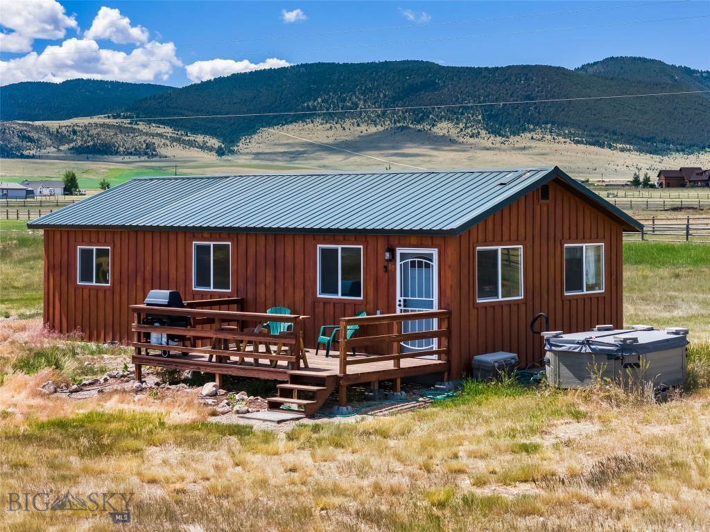 This adorable 820± square foot, 2 bed, 1 bath cabin is the perfect basecamp for year-round adventure in the Madison Valley! Set on 5± fully fenced acres with two loafing sheds, it's ready for your horses and outdoor lifestyle. The home features beautiful walnut hickory hardwood floors and custom cabinetry in the primary bedroom, offering rustic charm with thoughtful finishes. A seasonal ditch runs through the property, and with paid water dues, you’ll have irrigation rights to keep your land green. After a day of fishing, hiking, or horseback riding, relax in the hot tub under Montana skies. There's also an RV hookup for guests or extended stays. Set up for a woodstove. Wildlife is abundant, and recreation is all around—just a short drive to Varney, Burnt Tree, or Eight Mile fishing access points, Axolotl Lakes, Ennis Lake, and thousands of acres of public land for hunting, riding, snow machining, and more. Only 10± miles from the vibrant town of Ennis with restaurants, shops, a grocery store, hospital, movie theater, and bowling alley. Bozeman, Yellowstone National Park, and Island Park, Idaho are all about an hour away. Don’t miss your chance to own this cozy, well-located getaway in the heart of southwest Montana! Information deemed reliable but not guaranteed. Buyers and their agents to verify all information to their satisfaction. Weeds sprayed July 2025.