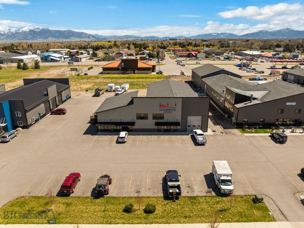 Large commercial condo for sale in Four Corners. This property has a ton of potential. With over 9000sqft of shop/office space, this should fit all your commercial needs. There are 6 garage bays with 12'wideX14'tall doors. 5 of the shop bays are heated with floor drains. The office/retail area is approximately 2186sqft with options to set up as you'd like. Upstairs you'll find 4 office spaces and a large open area for a break room or area for office supplies. This unit is part of the Black Spring Master HOA; however, there are no HOA dues. Owner is responsible for all interior and exterior maintenance & snow removal. SQFT breakdown; 837sqft reception/bathrooms/break room; 4876sqft shop space; 2186sqft main level office/retail; 1755sqft upper-level office area. Buyers to verify all information to their satisfaction.