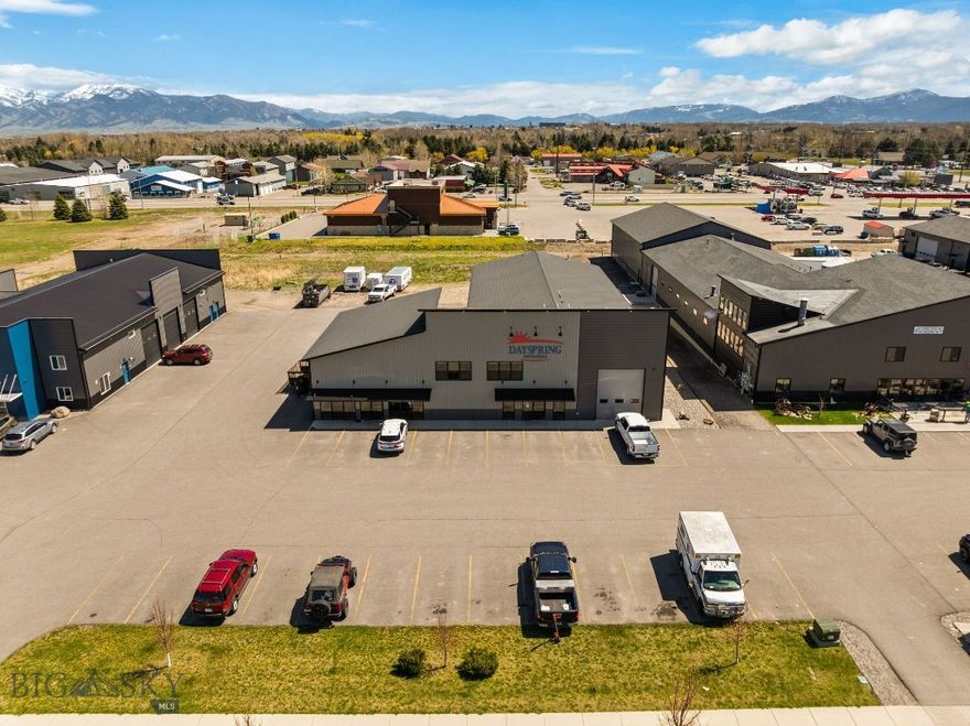 Large commercial condo for sale in Four Corners. This property has a ton of potential. With over 9000sqft of shop/office space, this should fit all your commercial needs. There are 6 garage bays with 12'wideX14'tall doors. 5 of the shop bays are heated with floor drains. The office/retail area is approximately 2186sqft with options to set up as you'd like. Upstairs you'll find 4 office spaces and a large open area for a break room or area for office supplies. This unit is part of the Black Spring Master HOA; however, there are no HOA dues. Owner is responsible for all interior and exterior maintenance & snow removal. SQFT breakdown; 837sqft reception/bathrooms/break room; 4876sqft shop space; 2186sqft main level office/retail; 1755sqft upper-level office area. Buyers to verify all information to their satisfaction.