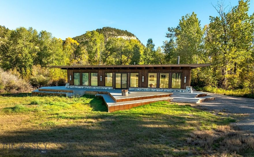 The Montana River Retreat may be the most attractive fly-angling property available in Montana today due to its extremely coveted Boulder River frontage and its thoughtfully designed mountain modern home already in place and waiting for a new owner to instantly enjoy.

The most significant and finite asset of this property lies in its abundance of water and exceptional angling opportunities. Spanning nearly half a mile, the pristine Boulder River flows alongside the property, offering deeded access to a world-class fishery. Renowned for its fast-moving, cold, and crystal-clear waters, the Boulder River is home to a robust population of both brown and rainbow trout. In addition to the river, the property features four spring-fed ponds, with one boasting large brown trout, as well as a spring-fed stream that meanders for approximately 2,500 feet. Together, these features not only enhance the property's aesthetic appeal but also hold the potential for further enhancement to optimize the aquatic experience.

Before building the current home on the property, the owners spent many evenings camping under the stars on the property, enjoying the sounds of the river and the beautiful setting of the property within the cottonwood meadows and captivating views. As they considered the construction of the beautiful home that sits on the property today, they wanted to keep that natural feel of camping under the stars as a vision for the construction. The end result is a beautiful 2,000± square foot triangle-shaped home that maximizes views at all angles, providing the ultimate indoor and outdoor experience.

The Boulder River Valley is one of the most highly sought-after destinations in Montana, celebrated for its quintessential Montana scenery and the charming small-town atmosphere of Big Timber, Montana. This property is conveniently located just 25 minutes from Big Timber and a short drive of approximately 1 hour and 25 minutes from Bozeman, which offers world-class amenities and an international airport.