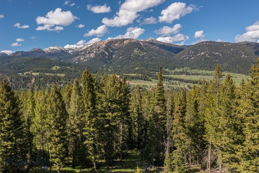 Morning Glory Court Homesite 71 presents an exceptional opportunity to own a private, 3.65± acre homesite in one of Big Sky, Montana’s most scenic and peaceful settings. Tucked at the end of a quiet cul-de-sac in the coveted Spanish Peaks North community, this expansive lot is bordered by mature trees and open space, creating a sense of seclusion while still offering convenient proximity to the heart of Big Sky. With panoramic views of the surrounding mountains and abundant local wildlife, the property offers the perfect foundation for a luxury mountain retreat.

Situated just 15 minutes from world-renowned Big Sky Resort, this homesite offers effortless access to downhill skiing, mountain biking, and year-round alpine adventure. The thriving Big Sky Town Center is a short 10-minute drive, offering dining, shopping, and community events. Nearby, Lone Mountain Ranch—a premier Nordic skiing and outdoor destination—provides additional access to hundreds of miles of trails for cross-country skiing, snowshoeing, and hiking.

This gently sloping parcel features a generous building envelope with excellent solar exposure, multiple potential homesite orientations, and protected view corridors. The land has year-round access via well-maintained roads and is ready for development, with essential utilities—including power and community water/sewer—available to the lot line (buyer to verify).

Enjoy the peace and privacy of a cul-de-sac location, where the only passing traffic may be deer, elk, or the occasional moose. Whether you envision a modern mountain lodge, a timber-framed getaway, or a multi-generational retreat, Homesite 71 offers the space, flexibility, and natural beauty to bring your vision to life.

Property is part of a well-managed HOA with architectural guidelines designed to preserve the integrity of the landscape and neighboring homes. Survey, HOA documents, and topographic information are available upon request.

Build your legacy in Big Sky and experience the best of Montana—wide-open skies, mountain adventure, and a community defined by nature, privacy, and possibility.