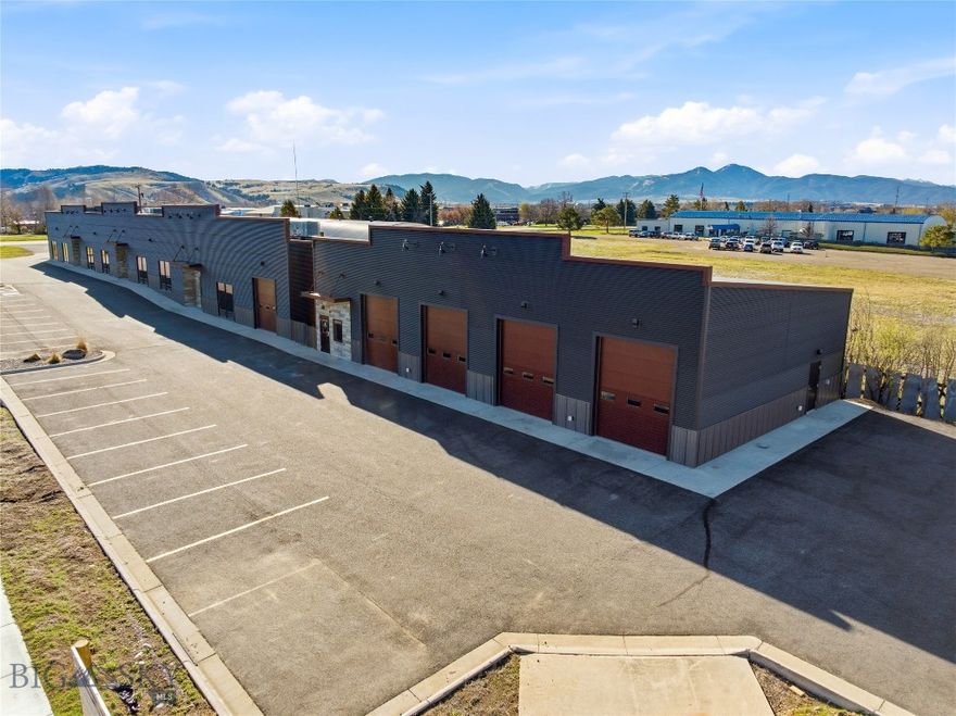 Turnkey commercial property ideally suited for an owner-user or investor in North Bozeman. Built in 2015, this well-maintained property features two buildings positioned on one acre with flexible configurations and strong leasing potential. Building 1 (8,772 SF) showcases an impressive glass and stone storefront with abundant natural light, 12.5’ ceiling heights, HVAC, three single-occupant ADA restrooms, and polished concrete floors. The layout allows for demising into up to three units, offering excellent flexibility for multi-tenant or single-user occupancy. Building 2 (3,040 SF) is designed for industrial or service-oriented use, featuring three 12’ grade-level overhead doors, a floor drain, reception area, single-occupant ADA restroom, and a laundry area with washer and dryer. The space is heated by two gas-fired unit heaters. Both buildings are stick-built with attractive metal siding and asphalt roofing, providing durability and low maintenance. The property includes a paved parking lot with 38 spaces, prominent building signage, and convenient access off N 7th Avenue. Strategically located in North Bozeman near the I-90 interchange, this property offers excellent accessibility and visibility, making it well-suited for a wide range of commercial uses.