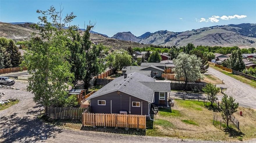 Welcome to your Montana retreat in the heart of Gardiner, just minutes from the North Entrance of Yellowstone National Park. Tucked away on a quiet street yet close to downtown, this beautifully updated 3 bedroom, 2 bath home with two additional bonus rooms offers the ideal blend of comfort, flexibility, and income-producing potential as a successful VRBO getaway. Designed for both everyday living and guest enjoyment, the bright, open main level features durable luxury vinyl plank flooring and a spacious kitchen that flows effortlessly into the living and dining areas, perfect for gathering after a day of adventure. Step outside to the expansive deck and take in scenic mountain views and star-filled Montana skies from the hot tub, or unwind in the sauna after exploring Yellowstone. Comfort comes year round with baseboard heat, a cozy pellet stove, and a brand-new energy efficient 4 zone mini-split heat pump system serving the main level rooms. The two lower level bonus rooms provide versatility for additional accommodations, home office space, recreation rooms, or future expansion opportunities. Located within walking distance to Gardiner’s restaurants, shops, parks, and schools, and less than a mile from Yellowstone’s iconic North Entrance, this turnkey property offers rare convenience for both homeowners and vacation guests seeking immediate access to hiking, fishing, wildlife viewing, rafting, and endless outdoor recreation. Whether you’re searching for a full time residence, vacation home, or short term rental investment, this move in ready Gardiner property delivers lifestyle, location, and opportunity.