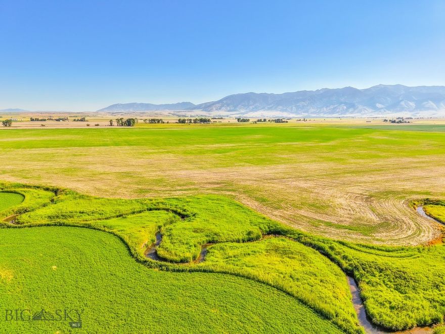 Discover this picturesque legacy farm located just outside of Bozeman with some of the oldest water rights from Ross Creek. Spanning 313 acres, this sub-irrigated farm offers alfalfa and naked oaks in addition to other crops which ensure income opportunities while maintaining exceptional privacy and breathtaking views of the Gallatin Valley. The conservation easement in place protects the land from development with the exception of an 8-acre build site, ensuring its agricultural and environmental value is preserved for future generations. Adding to its appeal, the South Fork Ross Creek meanders through the property, providing an excellent water source for irrigation and enhancing the scenic beauty of the farm. The 8-acre designated build site on the far north end of the property provides incredible privacy and unobstructed views.