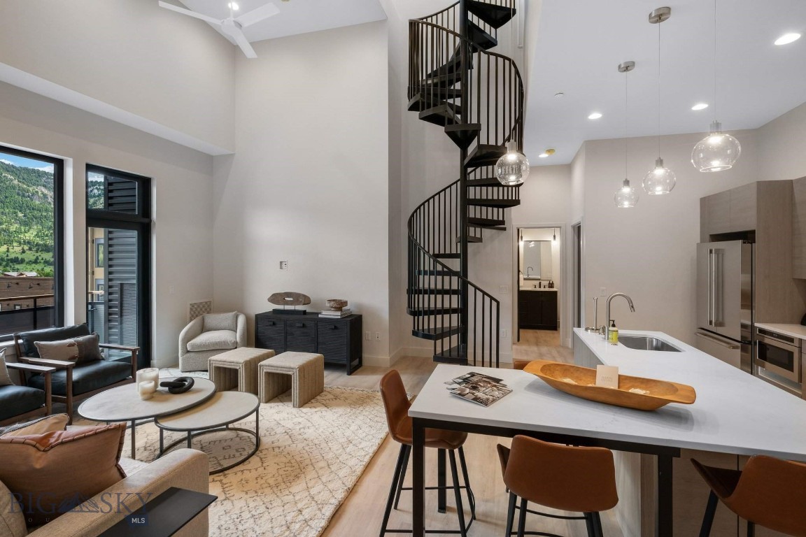 Elevate your everyday in Residence 3A, a thoughtfully designed 2-bedroom, 2.5-bath penthouse perched atop The Franklin—Big Sky’s newest boutique residential building in the heart of Town Center. Perfectly tailored for both quiet escapes and effortless entertaining, this home pairs refined mountain style with unbeatable walkability.
Inside, the airy floor plan is enhanced by 11-foot ceilings and curated finishes that strike the perfect balance between comfort and sophistication. Large windows draw in natural light and frame expansive vistas, while the open living space flows seamlessly onto a private rooftop terrace—complete with a hot tub—offering sweeping views of Yellow Mountain, Lone Peak, and the adjacent golf course.
Crafted by Bechtle Architects and built by Langlas Construction, The Franklin is a thoughtfully executed building offering the ease of lock-and-leave living with premium features: sound-insulated walls, heated underground parking, and private storage for your mountain gear.
From morning walks to your favorite coffee shop to evenings catching live music or dining nearby, Residence 3A puts you steps from it all. And when adventure calls, Big Sky Resort is just 10 minutes away, with river access and trailheads even closer. Move-in ready and designed for year-round enjoyment, this penthouse is more than a residence—it’s your personal launch point to the Big Sky lifestyle.