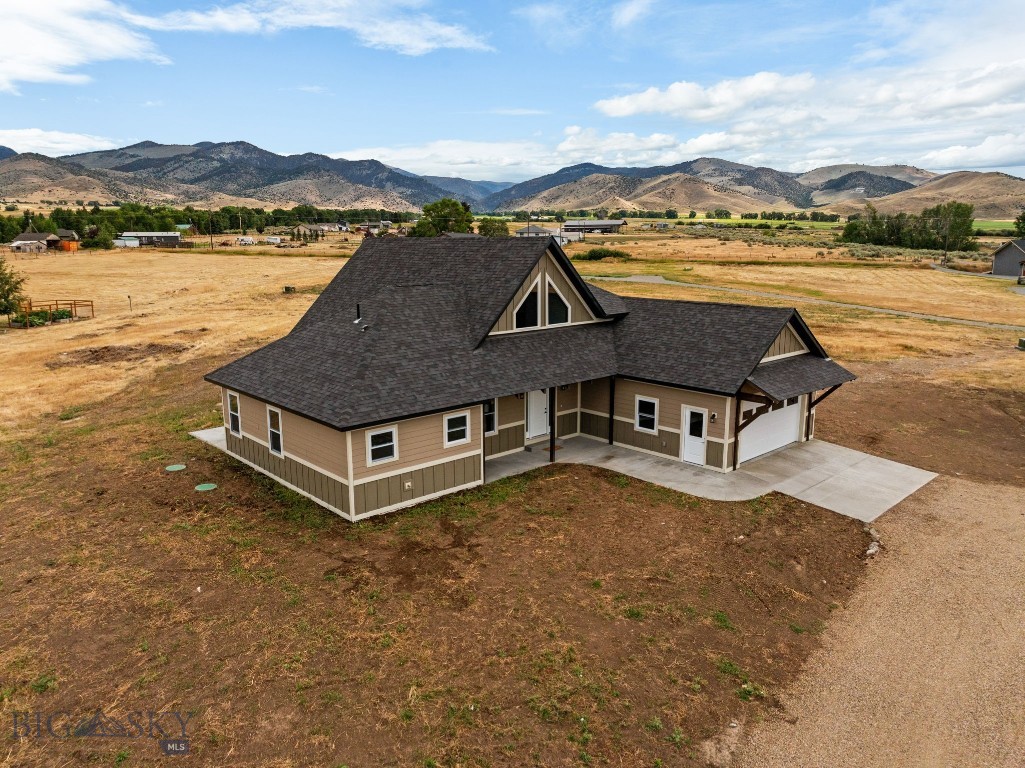 Brand new 2,040± SF home on 2.27± acres in the sought-after Homestead Subdivision, offering breathtaking views of the Tobacco Root and Ruby Mountain Ranges. Built with quality and durability in mind, this residence features an insulated concrete form (ICF) foundation and LP SmartSide siding for long-lasting performance. The main living area boasts vaulted ceilings with beams and dramatic floor-to-ceiling windows that fill the space with natural light while framing the stunning mountain scenery. A natural gas fireplace with impressive rock surround creates a warm and inviting focal point. The open-concept kitchen showcases concrete countertops, stainless steel appliances, and abundant workspace. An office or bonus room is conveniently located just off the front entry, ideal for working from home. The spacious primary suite provides a private retreat with a shower, soaker tub, and a generous 6' x 12' walk-in closet. Additional highlights include a 444± SF attached garage and a layout designed for both everyday comfort and entertaining. Experience modern comfort, high-quality construction, and the beauty of Montana living in this brand-new property, perfectly positioned for both privacy and accessibility to local amenities.