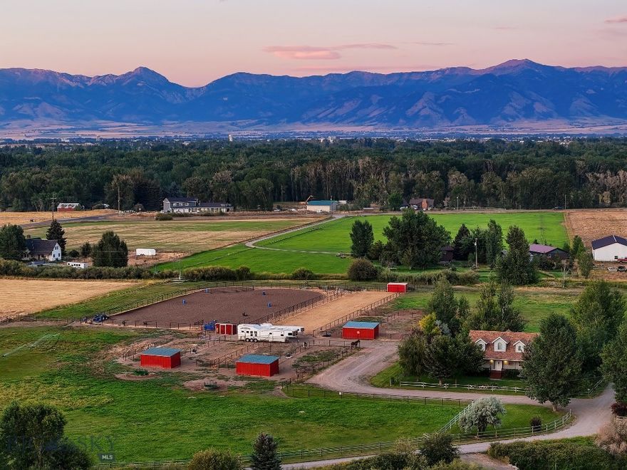 Experience the ultimate equestrian lifestyle on this exquisite 10.37 acre property, meticulously designed for roping enthusiasts and horse lovers alike. Located just 20 minutes from the heart of Bozeman, 15 minutes to the Bozeman Yellowstone National Airport, 10 minutes to the interstate that can take you and your horses to many rodeo adventures. 

This estate offers a harmonious blend of tasteful living and outstanding equestrian amenities. 
At the heart of the property lies a roping arena, featuring excellent footing, a water system, sturdy fencing, and an automatic Priefert chute, separate calf roping arena with its own chute, a return alley set up for team roping, holding pen/structure for bulls/calfs The property is fully equipped with 8 dry lots - each with shelter (mini pole barns), year round frost free auto waterers & power. Three large irrigated pastures, two with live water, provide ample grazing for several horses. Two separate loafing sheds for hay storage and a dedicated tack and feed shed ensure space for all your equine supplies and gear.

Beyond the exceptional roping facilities, the property boasts a beautifully remodeled farm style home with 4 bedrooms and 3 bathrooms, perfectly positioned to take advantage of the stunning surroundings. Imagine enjoying morning coffee on the spacious porch, overlooking your horses grazing in the pasture, or unwinding in the evening while soaking in the hot tub & gazing at the Bridger Mountains.

This property represents a truly rare opportunity to own a world-class roping and equestrian retreat, perfect for dedicated trainers, competitive ropers, someone who wants to board horses or anyone seeking a peaceful and fulfilling equestrian lifestyle. 

Privacy, minimal covenants and no HOA.
Don't miss this chance to live your equestrian dream! Schedule a private tour today and discover all that this exceptional property has to offer. 

Additional features include:
- Well-maintained pastures, providing excellent grazing for several horses.
- Live water runs through two of the pastures with water rights out of the Lewis Ditch
- Hand line irrigation system with pump.
- Set up to easily board horses with ample shelter, power & water.
- Proximity to Bozeman, Belgrade, Montana State University, offering amenities, dining, rodeos and community events.