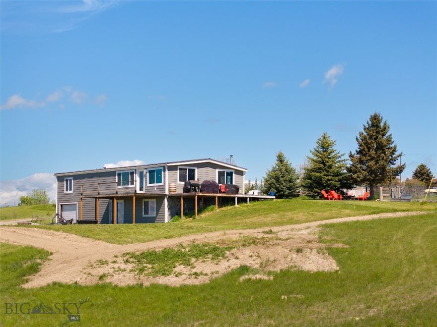 Perched on a high bench just north of Belgrade, this 9.38-acre property offers some of the most spectacular views in the valley. Enjoy panoramic, unobstructed vistas to the east, south, and west—truly a rare find. While the 1,404 sq ft manufactured home on an equally sized unfinished basement offers 3 bedrooms, 3 bathrooms, a garage, and plenty of space to spread out, the true value lies in the land and setting. Whether you're dreaming of a hobby farm, horse property, or simply a private retreat with unmatched views, this acreage has endless potential. Additional features include a hot tub for soaking under Montana skies, a greenhouse for year-round gardening, and a 2022 Kioti CK2610 tractor with loader, tiller, angle blade, and mower to help you work the land with ease. Bring your animals, your vision, and your appreciation for wide open space—this is Montana living at its best.