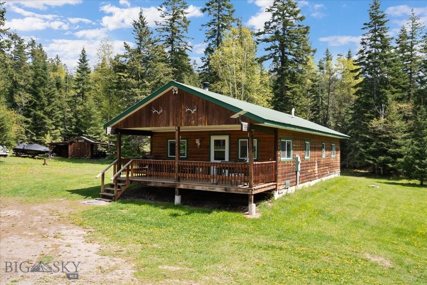 Country Living with near end of the road privacy - A rare opportunity to own 2.45 acres of mostly flat forested land with mountain views! This 2-bedroom, 1 bathroom, 1,128 sq ft log sided home features luxury vinyl plank flooring, open concept living and kitchen area featuring new appliances, landscaping and an awesome 40x50 fenced garden started with strawberries and rhubarb. The open concept living area is warm and inviting with electric baseboard heat and a wood burning stove to keep you cozy through Montana winters. The property includes a storage shed, rustic stable, and a detached shop with loft & wood burning stove. Perfectly located just minutes from Bigfork, Swan River access, Swan Lake, and Flathead Lake — with Glacier National Park less than an hour away.