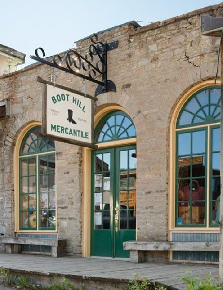 A rare chance to own a true piece of Montana history—right on Main Street in Virginia City.

Boot Hill Mercantile isn’t just a building; it’s a chapter of the Old West. This iconic property was the original home of *The Madisonian* newspaper and remains one of the *very few privately owned commercial buildings* in town, a true rarity in a community where most properties are state-owned. Opportunities like this simply don’t come up often.

From the moment you step inside, the place speaks to you. Original hardwood floors creak with history, vintage fixtures and signage set the tone, and the solid stone façade reminds you this building has stood here since the mid-1800s. Visitors routinely stop, take it all in, and say, *This is the real Virginia City.* It’s memorable in the best way.

Today, the building operates as a successful mercantile and gift shop, benefiting from steady foot traffic from tourists, history lovers, families, and locals who appreciate authentic places with soul. At approximately *1,971 square feet*, the space feels welcoming and manageable, with an open layout that easily supports a range of possibilities. Continue the current retail operation or reimagine the space as a café, gallery, artisan shop, bookstore, or small museum that complements the town’s historic character.

The sale includes the *building*, nearly all *fixtures*, and *inventory at closing*, making this a true turnkey opportunity with income potential from day one.

Virginia City is one of the most complete preserved frontier towns in the American West, drawing visitors for gold-rush history, live theater, reenactments, stagecoach rides, and immersive Old West experiences. Owning a business here means more than investing in real estate, it means becoming part of a living story that continues to draw people from around the world.

If you’ve been searching for a *commercial property with authenticity, visibility, income potential, and the rare advantage of private ownership*, Boot Hill Mercantile offers something truly special—an opportunity rooted in history and ready for its next chapter.