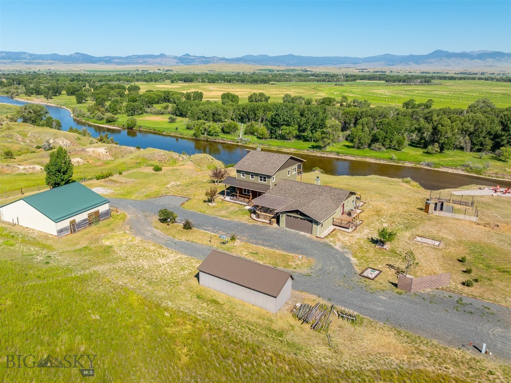 River Front Paradise with Breathtaking Views! Enjoy stunning panoramic vistas of the Jefferson River, surrounding mountains, and sweeping valley from this rare and remarkable property. Watch wildlife and waterfowl from your private second floor master deck in the morning, then unwind in the evening in the peaceful saltwater hot tub. Originally built in 2006 with a beautiful addition completed in 2024, this well-appointed 4 bedroom, 4 bath home blends great design, tons of Montana character and comfort. Featuring an extra large dining room, interior brick and rock accents, 2 fireplaces, solid wood flooring, a wraparound deck, and thoughtful high quality designer finishes throughout. The property is fully equipped with an RV 30-50 amp full hookup, A/C, a shop/barn with 3 stables and water, a heat source, a lean-to, and a fire pit area at the waterfront’s edge with sunset views to die for. Step out your back door and fish or float the river, enjoy caring for your livestock, tend to the built in garden area, or simply relax and take in the serenity. Perfect home for entertaining with 3 onsuites! Homes like this rarely come on the market - don’t miss your chance to own this Montana gem!