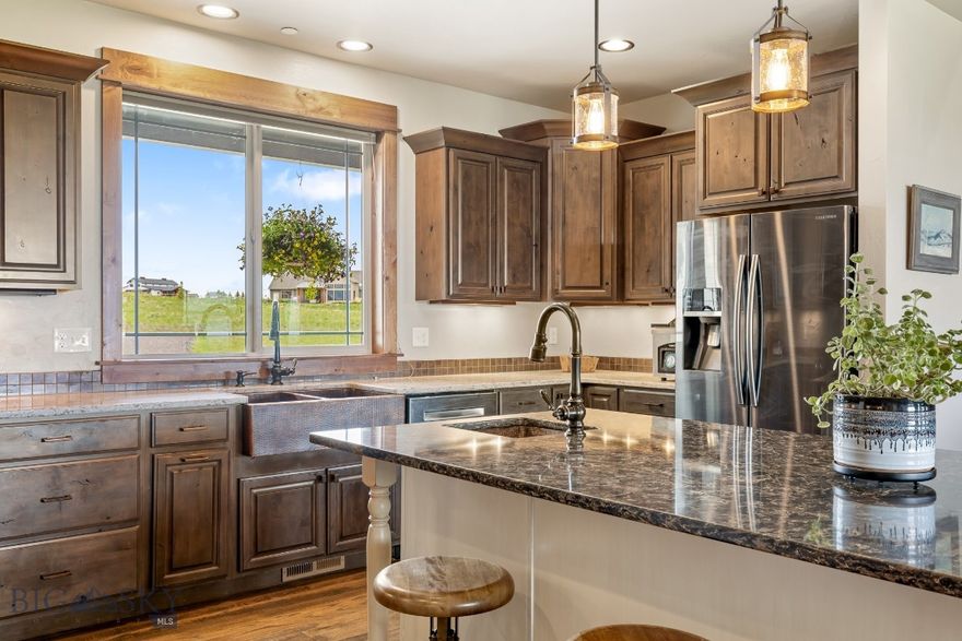 Discover the perfect blend of rustic charm and modern comfort in this spacious 3500+ finished home with breathtaking views of three mountain ranges just 30 minutes from Bozeman. The thoughtfully designed open floor plan invites comfortable living and effortless entertaining. All 4 bedrooms include a walk-in closet, and the home offers a dedicated office (with closet), a bonus room upstairs, and an oversized laundry room for ultimate functionality. The open kitchen features a extra-large island, copper farmhouse sink, a wet bar, walk-in pantry, and generous dining space—perfect for hosting gatherings. Rich Knotty Alder doors and cabinetry, along with rough-cut wood floors in the kitchen and dining areas, lend warmth and character throughout. Ceilings ranging from 9 to 11 feet enhance the home's expansive feel. Retreat to the primary suite, complete with a private sunroom, two walk-in closets, and large en-suite bath. Cozy up in the living area by the gas fireplace or step outside to relax under the large, covered patio—ideal for enjoying Montana’s summer evenings. An oversized three-car garage includes built-in shelving and a utility sink, and the property offers ample space to add a workshop or barn for horses. Designed with efficiency in mind, the home features multi-zone heating, a heat pump for increased air transfer of cool and warm airflow, two hot water tanks, a fire suppression system, and a lawn sprinkler system. Approx 2 acres with invisible fence of the almost 4 acre property. Of the approximately 5600 sq ft footprint, the unfinished 2,000+ sq ft basement is already framed, wired, and rough plumbed for two giant potential bedrooms/storage rooms, 2 main rooms and an additional bathroom—offering endless possibilities for customization.