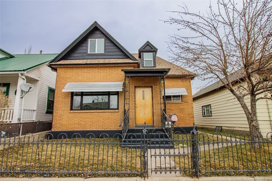 UPDATED MIDTOWN CLASSIC. This spacious brick home features four bedrooms—one on the main floor and three upstairs. The full bathroom includes dual sinks and a vanity counter. Numerous updates in the past year include a new roof, new sod, updated kitchen with stainless steel appliances, flooring throughout, siding on the main house, fresh paint, some light fixtures and doors, and more. Property also includes a detached studio back house currently rented and ready for some TLC.