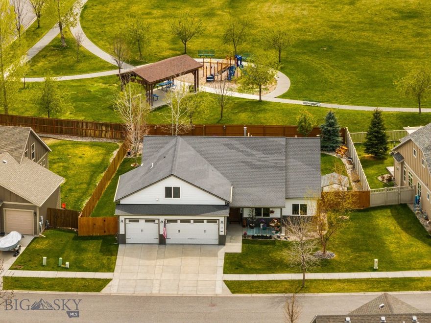 Set on one of the best lots in Gallatin Heights, this super charming home offers direct access to one of the neighborhood parks right out your back gate, along with beautiful Spanish Peaks views from the covered back patio and Bridger Mountain views from the front. You’re welcomed by a warm entry that opens into the living room and flows seamlessly into a bright, open kitchen designed for easy living and entertaining, featuring custom black walnut cabinetry, a gas range, beautiful surfaces, large windows that bring in great natural light, and a door leading straight out to the covered patio. The living room is anchored by a gas fireplace with a stunning custom black walnut mantel, adding warmth and character to the space. Just off the kitchen, a spacious mudroom and laundry room connect to the heated three-car garage, offering excellent storage and everyday functionality. The layout lives like a single-level, with the primary suite tucked privately on one side of the home featuring its own patio access, dual walk in closets with custom built-ins, and a generous ensuite with a tile shower, soaking tub, and split vanities. Two additional bedrooms and a full bathroom are also located on the main level. Upstairs, you’ll find a versatile bonus space or guest retreat complete with a full bathroom, perfect for visitors, a media room, or a quiet escape. With central A/C, a great-sized lot, access to trails and multiple parks within the community, and convenient proximity to the airport, Big Sky, and downtown Bozeman, this home brings together comfort, location, and lifestyle in all the right ways.