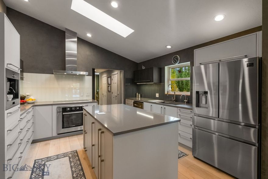 NO KNOWN COVENANTS - NO KNOWN ZONING.  MULTIPLE REVENUE STREAMS.  Owner occupies the uppler levels, which has been beautifully remodeled with 3 bedrooms, 3.5 baths, an office, living room and additional family room, as well as an exercize room with beautiful Europen Modern design throughout. The basement offers 2 additional bedrooms with egress windows, separate entrance, walk out basement, living room, kitchen, full bath and bonus room.  There is a gorg3ous, detached ADU/stuidio aoartebt on the property with separate septic that is currently operated as an Airbnb.  In addition, the property features a heated 5000 sq ft shop with indoor pickleball court, an office and multiple separate heated bays with storage above, perfect for all your toys, lease options, or commercial space.  Image listening to the waterfall feature and enjoying the swim pond. (Using it as a commercial property may require additional requirements by the County Health Department), however since this property is unzoned, it may be utilized for commercial purposes. The property offers a rare combenation of natural serenity, expansive living, and exceptional versatility, all just 10 min from downtown Bozeman.  Tons of opportunities with this amazing property not to mention just steps to the National Forest, a short 8 minute drive to Hyalite Reservoir and in close proximity of world class skiing, fishing, rafting and more.  Potential to use rental income to qualify for this property as well.  Too many upgrades to list, you just have to tour the property to get a sense of all the possibilities.  ALSO LISTED AS A SINGLE FAMILY HOME AND COMMERCIAL PROPERTY.  SEE MLS 406262 AND 408397