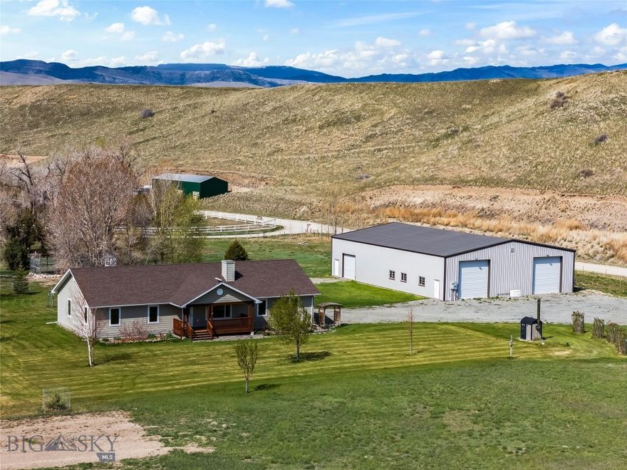 This 7.83± acre property offers no covenants, irrigation and livestock water rights from Lower Deep Creek, creek access, mature trees, garden space, and a fruit orchard. A private picnic area with custom firepit overlooks the creek. The property includes four irrigation rights, livestock water rights, and a well recorded at 22 GPM. A 220V electric service and pad are in place near the creek for an irrigation pump. The custom-built 1,524± SF single-level ranch home features 3 bedrooms and 2 bathrooms with a functional layout and abundant natural light. The kitchen offers hardwood cabinetry and solid surface countertops. The primary suite overlooks mature cottonwoods and the creek. A laundry/boot room connects to the attached two-car garage with two bonus rooms for storage or workspace. Zoned radiant floor heat is powered by an outdoor wood boiler system designed to heat the home, water, and shop and/or by propane. An air exchange system and seller-owned 1,000-gallon propane tank are included. The 60’ x 80’ steel-framed shop with 24’ center height includes a finished, insulated workshop with floor drains, radiant floor heat, overhead heater, compressed air lines, exhaust fan, and dedicated circuits. A 14’ overhead door services the workshop, while two additional 14’ drive-through doors and a 10’ side door provide ample space for RVs, boats, and equipment. A bathroom is stubbed for plumbing. A standby generator powers both home and shop. The irrigated hay field has produced consistent yields in years past and, with no covenants, supports horses or livestock. The garden area features quality soil and established timed drip irrigation for beds and orchard trees. Located approximately five minutes from the Townsend business district in Townsend, the property offers convenient access to amenities while maintaining a private setting. Helena is approximately 40± minutes away and Bozeman approximately one hour±. Maintained year-round access.See the virtual tour link for a 3D tour of the home. Call your real estate professional today to schedule a private tour!