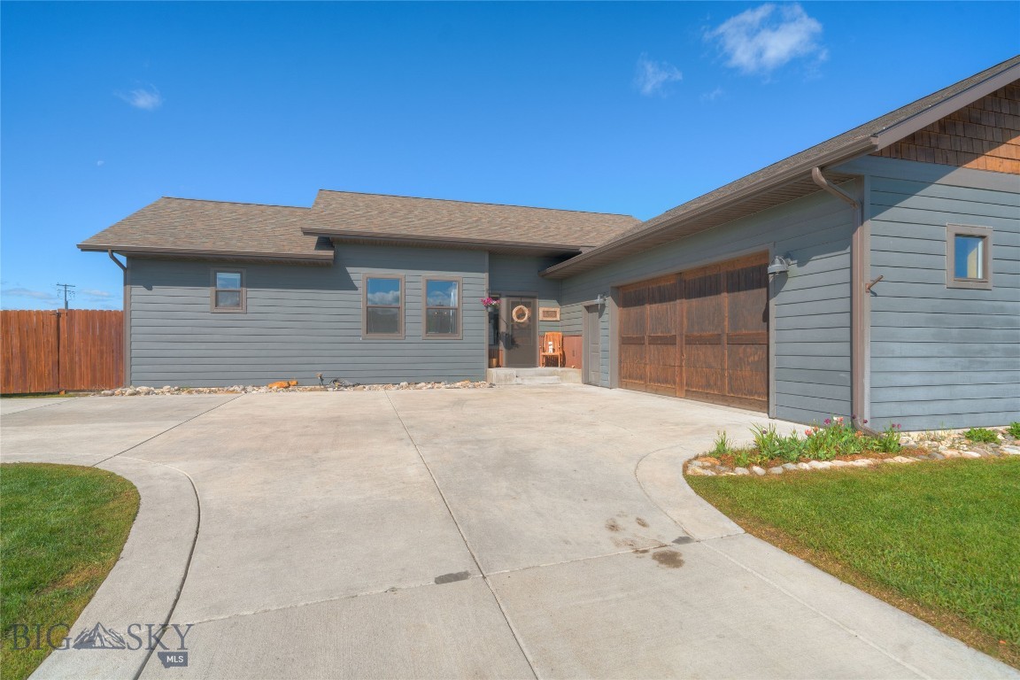 Seller is Offering $10,000 Credit for Buyer's Closing Costs &/or Rate Buy Down. This Beautifully Designed Ryen Glenn Home, Built by R&H Homes, is One of Only Two in the Entire Subdivision! Discover Comfort and Style in This Newly Priced, Quality Built Single-Level Home Situated on a Generous Half-Acre Lot. The Fenced Back Yard Features a Gate for Easy Access to State Land, Offering Peaceful Mountain Views and Plenty of Room to Enjoy the Outdoors. This 3-Bedroom, 2-Bath Home Features a Thoughtfully Laid Out Floor Plan with Tons of Natural Light, Engineered Hardwood Floors and Rich Wood-Wrapped Windows Adding Warmth and Craftsmanship to Every Room. At the Heart of The Home Is the Convenient Kitchen, which is Both Functional and Striking with Concrete Countertops, Live-Edge Wood Bar Seating, a Sizable Pantry for Great Storage and Seamless Flow into the Dining Area. Anchored by a Floor-to-Ceiling Stone Fireplace, the Dining Space is Perfect for Both Everyday Living & Entertaining. The Split-Bedroom Design Ensures Privacy for the Primary Suite with a Generous Walk-In Closet and a Beautifully Finished En Suite Bath Featuring a Custom-Tiled Shower and Double Vanity with Rustic Framed Mirrors. Step Outside to the Spacious Patio with SunSetter Awning—Ideal for Outdoor Entertaining and Enjoying Montana’s Seasons.
The Spacious ½ Acre Back Yard Features Raised Garden Beds, UG Sprinklers and Room to Roam. Check Out the Oversized 2 Car Garage with Built-in Shelving & Gas Heater Hookup. The Difference is Definitely in the Details of this Quality Built Home – The Perfect Balance of Style, Function & Outdoor Beauty.