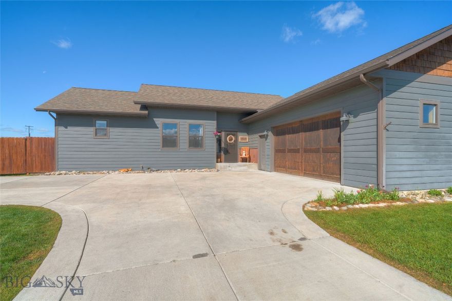 Seller is Offering $10,000 Credit for Buyer's Closing Costs &/or Rate Buy Down. This Beautifully Designed Ryen Glenn Home, Built by R&H Homes, is One of Only Two in the Entire Subdivision! Discover Comfort and Style in This Newly Priced, Quality Built Single-Level Home Situated on a Generous Half-Acre Lot. The Fenced Back Yard Features a Gate for Easy Access to State Land, Offering Peaceful Mountain Views and Plenty of Room to Enjoy the Outdoors. This 3-Bedroom, 2-Bath Home Features a Thoughtfully Laid Out Floor Plan with Tons of Natural Light, Engineered Hardwood Floors and Rich Wood-Wrapped Windows Adding Warmth and Craftsmanship to Every Room.  At the Heart of The Home Is the Convenient Kitchen, which is Both Functional and Striking with Concrete Countertops, Live-Edge Wood Bar Seating, a Sizable Pantry for Great Storage and Seamless Flow into the Dining Area. Anchored by a Floor-to-Ceiling Stone Fireplace, the Dining Space is Perfect for Both Everyday Living & Entertaining.  The Split-Bedroom Design Ensures Privacy for the Primary Suite with a Generous Walk-In Closet and a Beautifully Finished En Suite Bath Featuring a Custom-Tiled Shower and Double Vanity with Rustic Framed Mirrors.  Step Outside to the Spacious Patio with SunSetter Awning—Ideal for Outdoor Entertaining and Enjoying Montana’s Seasons. 
 The Spacious ½ Acre Back Yard Features Raised Garden Beds, UG Sprinklers and Room to Roam.  Check Out the Oversized 2 Car Garage with Built-in Shelving & Gas Heater Hookup. The Difference is Definitely in the Details of this Quality Built Home – The Perfect Balance of Style, Function & Outdoor Beauty.