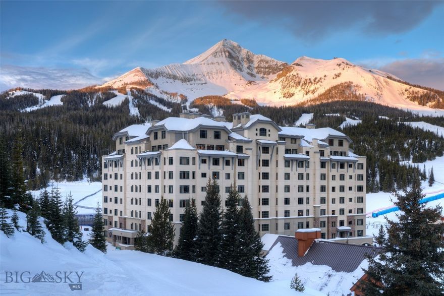 Enjoy stunning Lone Mountain views from this newly remodeled two-bedroom condominium in the prestigious Summit Hotel/Condominium. Perfectly positioned beside the Ramcharger 8 and Swift Current lifts, this residence offers one of the best true ski-in/ski-out locations in all of Big Sky.
This unique tri-hull floor plan features two bedrooms configured as three adjoining hotel rooms with interconnecting doors—an ideal layout for hosting family, friends, or rental guests. Sold fully furnished and turn-key, the spacious unit comfortably sleeps up to 10 people. The central room serves as the main living space, offering a kitchen, dining area, bathroom, and a cozy living room with a fireplace, Murphy bed, and fold-out sofa. One end suite functions as the primary bedroom, complete with a king bed, corner sofa, fireplace, wet bar, and private bath. The opposite end suite includes two queen beds, a wet bar, and a full bathroom.
Enjoy full-service, four-star amenities including a newly renovated indoor/outdoor heated pool and spa, a Himalayan salt sauna, expansive fitness center, outdoor hot tub with mountain views, underground parking, on-site fine dining, and premium concierge and valet services—all designed to elevate your mountain lifestyle.