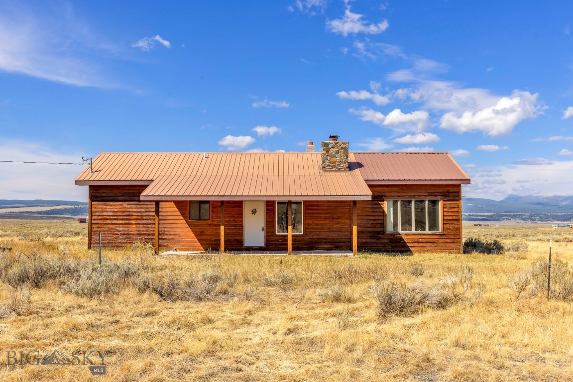 Welcome to Sportsman’s Paradise! This 1,056± sq. ft. cabin, with additional garage space, sits on 20 acres of Montana beauty and offers the perfect blend of rustic charm and outdoor adventure. With 2 bedrooms and 1 bath, it’s an ideal summer fishing or fall hunting retreat, or add plowing equipment and make it a year-round home. The interior highlights its Montana roots with Douglas fir flooring, cedar-lined walls, and a stunning fireplace crafted from Quake Lake stones with a walnut mantle. There is also a woodburning stand alone fireplace plus cadet wall heaters. Bonus room for your home office, craft room or extra sleeping space for guests. Outdoors, you’ll find endless recreation nearby: fish the famed waters of the Madison River from Three Dollar Bridge and Raynolds Pass fishing access sites, hike from Sheep Creek or Mile Creek trailheads, or explore Cliff, Wade, Quake, and Henry’s lakes just minutes away. When you’re ready for a change of pace, a short drive takes you to Big Sky, MT, Island Park, ID or West Yellowstone, MT, with quick access to one of five Yellowstone National Park entrances. Ennis is just 45 minutes away for shopping and conveniences. Use the cabin for guests and build another home. Add a barn and bring your horses! With a little maintenance and your personal touches, this cabin has all the makings of your Montana getaway or your full-time haven in the heart of Big Sky Country.