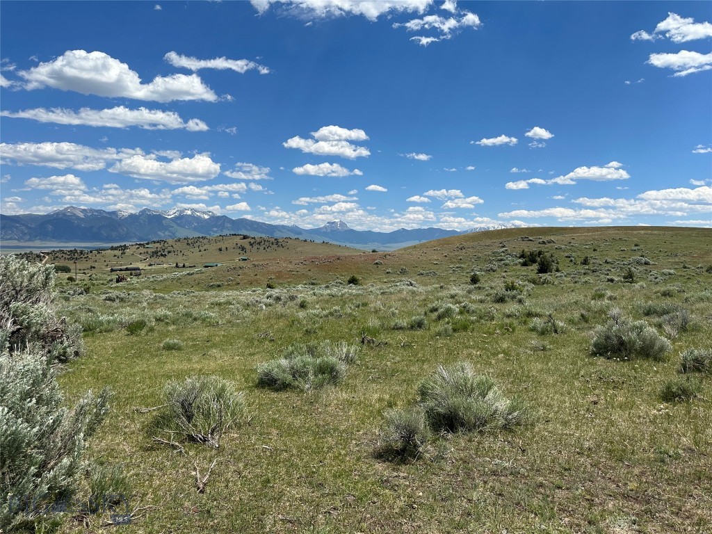 This 6.72-acre parcel in the Shining Mountains Subdivision is a true gem for outdoor enthusiasts and nature lovers. Situated in the serene northwestern corner of the subdivision, the property is fully fenced, perfectly suited for those who want to keep horses. Additionally, the presence of a seasonal spring running through the northern part of the lot adds to its natural charm. Notably, the west side of the lot offers breathtaking views of Fan and Sphinx Mountain, further enhancing its appeal. Surrounded by an abundance of outdoor activities, the area caters to ATV, UTV, and horseback riders alike. The nearby Gravelly Mountains and expansive public lands provide limitless opportunities for exploration and adventure. For avid anglers, the world-renowned Madison River beckons with its exceptional fly-fishing opportunities. Convenient access to Varney Bridge and ownership privileges in the subdivision, including private access to Haypress Lakes, elevate the recreational potential of this property to another level. This parcel offers more than just land—it offers a lifestyle immersed in natural beauty and outdoor recreation. Whether you're seeking a retreat or a permanent residence in the picturesque Montana landscape, this property offers it all.