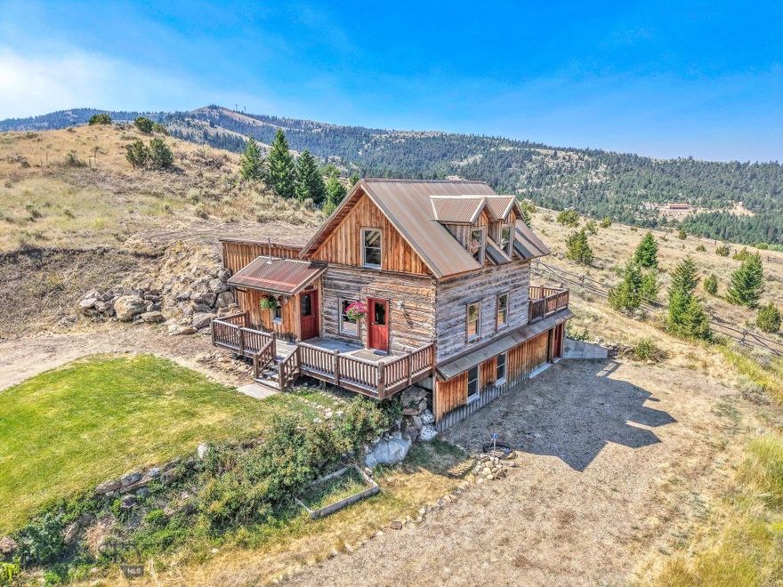 309 E South Street – Virginia City, MT

Crafted in 2007 with reclaimed hand-hewn square logs and weathered barnwood, this 2,620 SF home blends seamlessly with the historic charm of Virginia City while offering modern comfort and thoughtful design.

The main level features an open kitchen with island, flowing into a spacious great room ideal for entertaining. A main-floor primary suite showcases large windows that frame sweeping views over historic Virginia City, along with a clawfoot soaking tub and walk-in shower. Expansive decks, one at the front of the home and a private deck in back, create inviting spaces to enjoy the hilltop setting and surrounding scenery.

Upstairs, a lofty, light-filled studio provides flexible space for work or creative pursuits. The lower level includes two additional bedrooms, a full bath, and a family/theater room. Multiple skylights fill the interior with natural light throughout.

Set at the top of the hill and bordering public lands to the south, the property offers immediate access to thousands of acres for hiking, biking, skiing, snowmobiling, or ATV adventures. The town amenities include an ice skating rink & community center / gym. All of this comes with the unique character and sense of place that only Virginia City can offer.