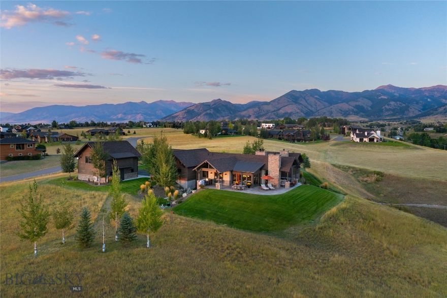 This 2018 Parade Home is a Modern Montana Masterpiece and perched atop one of Bozeman’s most coveted communities. This 4,835 sq ft residence in Springhill Reserve flawlessly blends rugged Montana charm with modern luxury design. Offering 4 bedrooms, 4 full bathrooms, and 2 half baths, every inch of this home was designed to showcase panoramic 360-degree mountain views, with the Bridger, Gallatin, Spanish Peaks and Tobacco Root ranges as your daily backdrop.

The main level welcomes you with soaring vaulted ceilings, exposed beams, and an open-concept living space anchored by a striking stone fireplace. A custom accordion wall of windows opens seamlessly to a covered patio with a second fireplace, blurring the line between indoor comfort and outdoor grandeur. A second patio also features a built in grill, warming drawer and a large sitting area. The chef’s kitchen is functional and stunning, featuring high-end appliances, an oversized island, and a custom steel-fabricated range hood—a true showpiece for the heart of the home.

Tucked privately on the main level, the primary suite is a sanctuary of its own, with vaulted ceilings, dual walk-in closets, a spa-like bathroom, and a private walkout patio framing spectacular Bridger Mountain vistas.
Downstairs, the home transforms into an entertainer’s dream: a full wet bar, game room, home gym, and bunk room are complemented by another large ensuite bedroom, spacious living area with a third fireplace, and a theater-style TV setup.

To top it all off, this property includes a 30' x 30' shop for your toys with a separate 850 sq ft. living space above, complete with a full bathroom, kitchenette—ideal for guests, a home office, or creative studio space. The shop also has custom cabinets, stackable laundry area, dog wash, and a 30 amp RV outlet

Whether you’re hosting gatherings, enjoying quiet moments with the mountains, or seeking the perfect blend of modern comfort and Montana soul—this home is truly one-of-a-kind.

Welcome to your mountain retreat reimagined built by Joe Robb Custom Homes