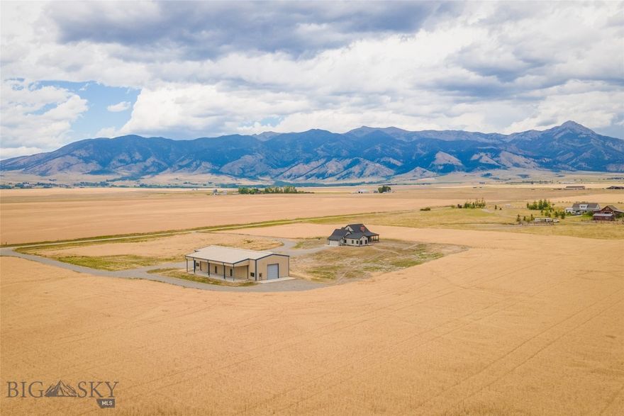 Here is an exceptional opportunity to acquire a remarkable 40-acre property in the Gallatin Valley. This idyllic setting offers breathtaking panoramic views of the Bridger Mountains with an abundance of wildlife in the area, providing a tranquil retreat while remaining conveniently located.
The single-story, custom-built home boasts three bedrooms and two and a half bathrooms, featuring an open floor plan with vaulted ceilings and exquisite hardwood floors. Natural light floods the interior, highlighting the meticulous attention to detail throughout. From the large kitchen and culinary island to the extensive primary suite, large windows provide surrounding scenic views to catch your eye at every turn. A spacious covered patio, accented with red brick, welcomes you and provides an ideal space for outdoor relaxation. The home is surrounded by a golden wheat field, and the landscaping is prepared with topsoil and ready for your personal touch.
Beyond the home lies a substantial +/- 4,600-square-foot heated shop, complete with 14-foot garage doors and additional lean-to space, perfect for storing equipment, vehicles, and recreational items. The property also features 220-amp service, full RV hookups, two 1,000-gallon propane tanks (serving both the home and shop), and a dosing tank with two installed septic systems – one septic for the existing structures and one septic for additional future home.
This property represents an unparalleled opportunity to own a piece of Montana's natural beauty, offering both comfort and practicality. I invite you to schedule a showing at your earliest convenience.