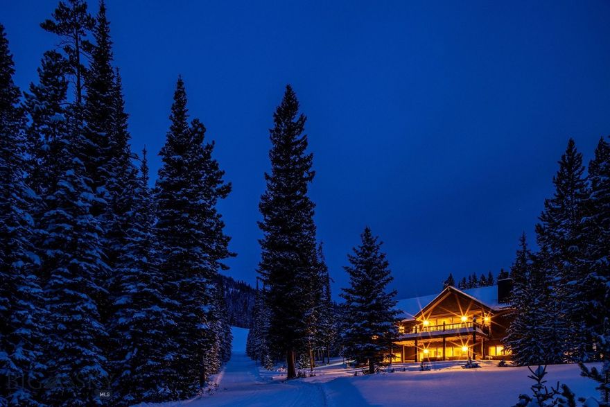 Located in the Diamond Hitch neighborhood of Moonlight Basin, this ski-in ski-out home at Big Sky Resort offers exceptional ski-out access with a groomed trail adjacent to the home leading to the Explorer Gondola and Pony lift. You can also walk a short distance to Challenger and be among the first on the upper mountain for powder turns, with ski-in return from much of Lone Peak. Set on 1.375 acres among mature pines with Spanish Peaks views, the setting feels distinctly mountain and wonderfully private. Inside, the vaulted great room features exposed timber beams, a tongue-and-groove wood ceiling, hardwood floors, oversized windows, and a stone-surround wood-burning fireplace. Numerous updates include a water filtration system and an updated kitchen designed for après and entertaining with Viking appliances, a generous center island, and a pantry, flowing into the dining area for easy hosting. The main-level primary suite includes deck access and a spacious bath. Step outside to a large deck, covered patio, and hot tub for year-round outdoor living in a true mountain setting. Sold furnished. Optional membership, upon approval, to Moonlight Basin provides access to additional amenities and services.