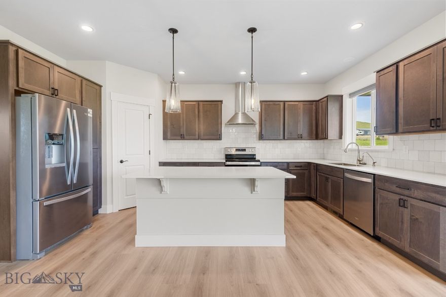 Built in 2022, this stunning home is not just a place to live—it's a gateway to an unparalleled lifestyle. Imagine thriving in this southern exposure home with one of three spacious bedrooms, unwinding in two modern bathrooms. Enjoy the versatility of a bonus room (or 4th bedroom) upstairs, complete with floor heating, perfect for cozy evenings. With a generously sized two-car garage, this residence blends convenience and charm. Nestled in the picturesque community of The Village at Elk Ridge, you will benefit from meticulously paved roads, a charming park, and breathtaking nature views. 
Step into your private oasis with a large sliding glass door leading to a concrete deck that overlooks a lush, newly fenced backyard. An impressive 6-foot dog-ear privacy fence, constructed from sturdy 5 1/2-inch wide cedar pickets, withstands the harshest storms—your pets can enjoy a sprawling fenced playground (880 square foot fence). There’s an additional 4-foot gate and large barn door for ample space to build a shop—bring your toys! This expertly designed fence ensures your privacy while allowing you to savor captivating views of surrounding mountains, farmland, and rolling hills, transforming every moment at home into an extraordinary experience.
The master suite is a serene retreat, bathed in natural light, featuring scenic views, a spacious walk-in closet, and a lavish master bath with a rejuvenating rain shower—your slice of paradise. Recent upgrades enhance this home’s appeal, including custom blackout blinds in the bedrooms with remote controls for convenience. The kitchen boasts an under-the-sink reverse osmosis water system and a whole-house Pure Water Technologies softener, ensuring exceptional shower experiences and pristine laundry.
Top-of-the-line washer and dryer appliances grace the spacious laundry/mudroom, completing the picture of comfort. Safety is paramount, with powered smoke detectors installed for your peace of mind. Outside, an upgraded, fully paved concrete driveway stands the test of time, allowing you to park your RV with confidence, even in winter. Upgraded with an additional 1,546 sf of concrete, with installed sprinkler zones for effortless turf maintenance and room for an additional workshop or ample garden.  Located in Three Forks with easy access to Bozeman and plenty of recreational options! Don’t let this chance slip away—make this dream home yours today!