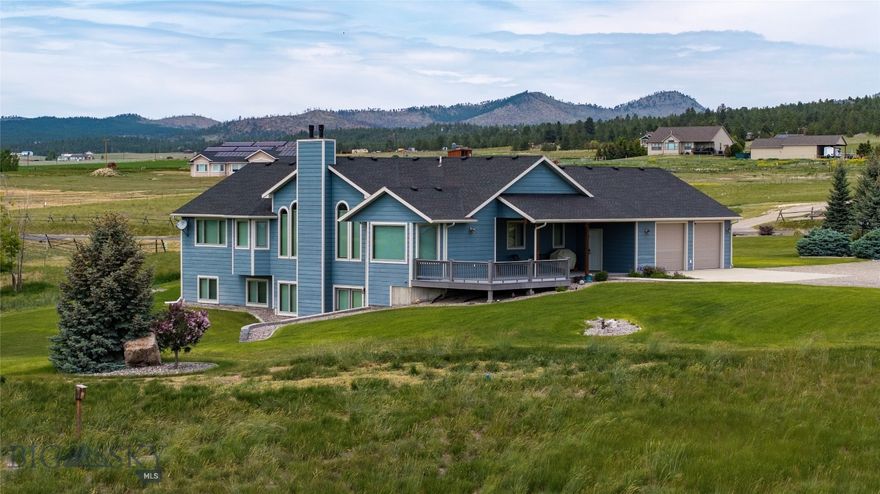 This exceptional home blends timeless design with modern comfort, framed by panoramic views of Lake Helena and the surrounding mountains. The open floor plan showcases vaulted ceilings, a dramatic stone fireplace, and expansive windows that capture the landscape in every season. The gourmet kitchen features rich cabinetry, ample counter space, and smooth flow into the dining area and deck—perfect for both quiet evenings and entertaining. The main floor also includes a private office, while the primary suite offers a spa-like retreat with a soaking tub and sweeping views. The finished walkout basement expands the living space with a cozy fireplace, trophy room, craft room, entertainment room, and guest quarters. Features such as ADA accessibility, central vacuum, and security system add ease and peace of mind. Outdoors, enjoy landscaped grounds with underground sprinklers, patios, an attached garage, and large detached shop with room for animals, pasture, and add irrigation if desired.