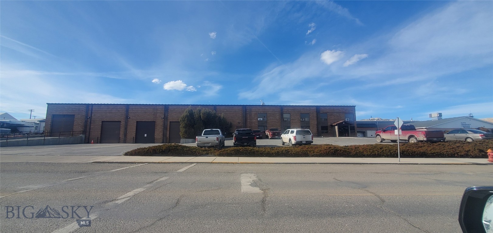 This Large Industrial Warehouse is situated in the heart of the Butte Warehouse District. Built originally for a Beer & Wine Distribution business in 1990. Cement block construction with a metal roof & a steel truss system. Hot water heat in the offices, the warehouse has heat & air conditioning. The Warehouse is approx. 22,940', the office area approx. 5,000 sq ft. The Warehouse area features 2 semi loading docks, 3 industrial overhead doors, 1 bay door with drive-in ramp to access the warehouse. The Warehouse features approximate 20 ft ceilings with a cooler, an abundance of storage, a 2-story office area with a large reception office, a walk-in safe, 5 office areas on the main floor, executive offices on the second floor, a large conference room, 2 restrooms on the main floor& 1 on the upper level 2 have showers. There are 4 additional door exits in the building, parking for 27 vehicles, plus additional in the yard area, 3 phase electric. The property is owned by the listing Broker.