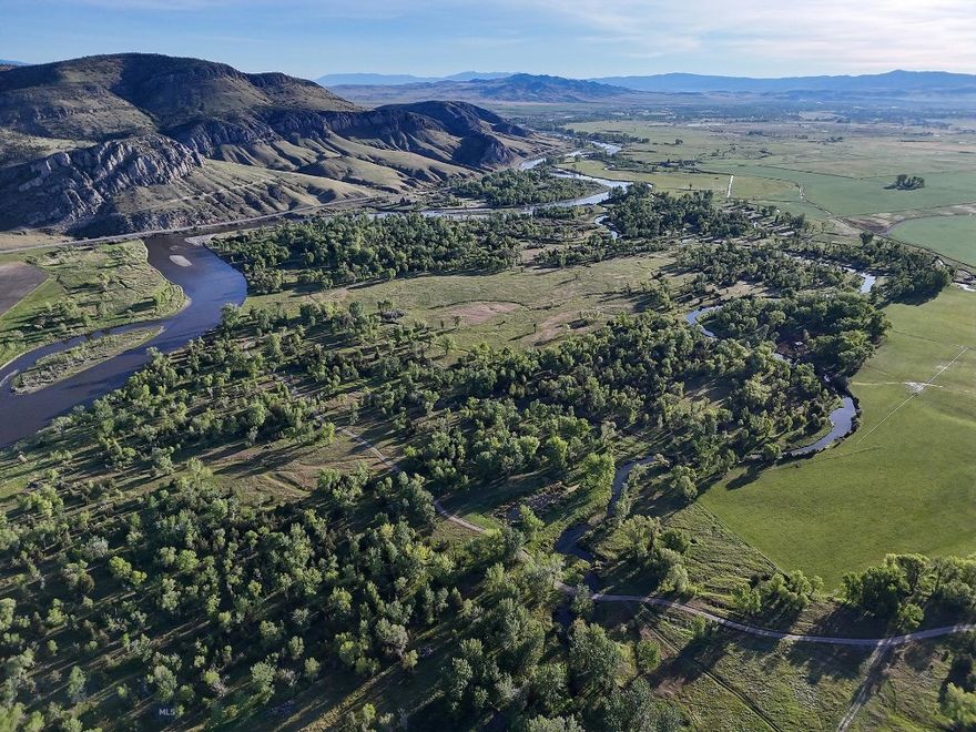 The Jefferson River Sporting Ranch is the epitome of a Montana riverfront ranch, boasting hundreds of acres of lush, wildlife-rich riparian bottomland, productive ranchland, recreational amenities, and outstanding views of the Bridger, Madison, and Tobacco Root mountains. The 423± acre property is nestled alongside approximately 1± mile of the Jefferson River, a few miles south of Three Forks, under 30 minutes from the Bozeman Yellowstone International Airport, and approximately 40 minutes from downtown Bozeman, Montana.

Perhaps the most unique aspect of the ranch is the lush, spring-laden bottomland along the Jefferson River. Here, springs, wetland complexes, and remnant river sloughs intertwine among hundred-year-old cottonwoods. The wildlife is prolific. A wide variety of waterfowl, including ducks (mallards, widgeon, blue-winged teal, cinnamon teal), Canada geese, and tundra swans, as well as geese, turkey, pheasant, eagles, sandhill cranes, and songbirds, are perpetually present. Big game, including whitetail deer, moose, and occasionally elk also call the ranch home.

The ranch is a blank slate with the opportunity to build a home or enjoy as a recreational retreat. Two suggested build sites with approved septic permits at each for five bedroom homes are already in place, allowing for a streamlined approach for a new owner to begin construction.

Jefferson River Sporting Ranch offers an unparalleled blend of outstanding wildlife habitat, productive ranchland, and convenient location, making it an ideal retreat for a new owner to create their own secluded, wildlife-rich oasis. The ranch is a clean slate, allowing for a new owner to build their legacy home or recreational retreat.