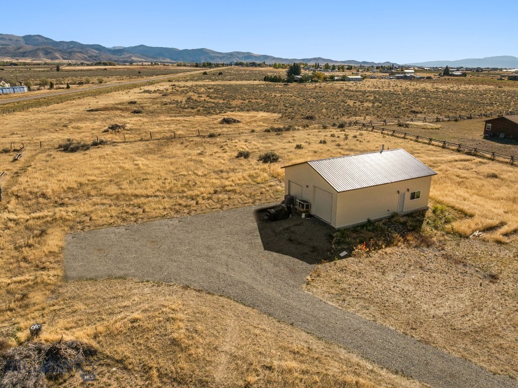 Enjoy the beauty of rural Montana on this 2.6-acre parcel located just outside Sheridan. With sweeping mountain views and quick access to both Sheridan and Twin Bridges, this property offers privacy, functionality, and proximity to endless outdoor recreation.
The property is ready for you to build your forever home, with essential infrastructure already in place. A newly built (2024) 30' x 40' insulated shop adds tremendous value, featuring 12-foot ceilings, a wood stove, full kitchen and bathroom, laundry hookups, and a private well and septic system. Most of the interior has been thoughtfully converted into comfortable living space, making it ideal as a full-time residence, weekend getaway, or base camp for hunting and fishing adventures.
With light covenants and close proximity to BLM and State land, this property provides an ideal blend of freedom and convenience for outdoor enthusiasts. Whether you're looking to build, expand, or enjoy it as-is, this is a rare opportunity to own usable, scenic acreage in one of Montana's most sought-after valleys.