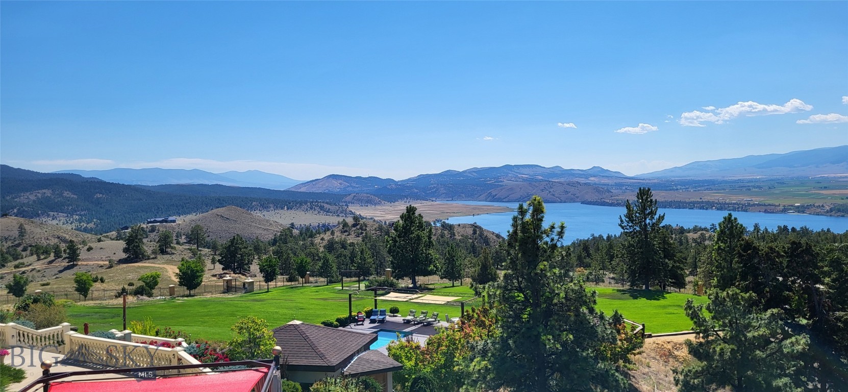 Welcome to The Ting, a spectacular Mediterranean-style estate that brings together stunning lake views, fantastic amenities, and luxurious accommodations. Ting is the sound of celebration. This home is about entertainment and fun. Your family and guests will enjoy the beautiful state of the art stainless steel pool, hot tub, boccia ball court, golf putting green, tiki bar, horseshoe pit, and an expansive lawn. Sit on the white sand beach area with a cool drink and take in the view. Adjourn to the fire pit to swap stories of the day’s adventures. The Ting is a private gated estate on 20 acres overlooking Hauser Lake. The property consists of two luxurious residents joined by a breezeway, making this the perfect property for multi-generations or co-owners. The 3650 sq. ft. main house has three bedrooms, an impressive great room with a wall of windows, chef’s kitchen, library, theater room, and office. The 3760 sq. ft. guest house has two en-suite bedrooms, a spacious great room with floor to ceiling windows to capture the view, large kitchen, sunroom in the tower, sauna, well-equipped home gym, and art studio. The beautiful, colorful gardens and waterfall invite you outdoors. Large patios and deck areas are perfect for entertaining and outdoor dining. Home is being sold furnished. Guest house is currently a short-term rental.