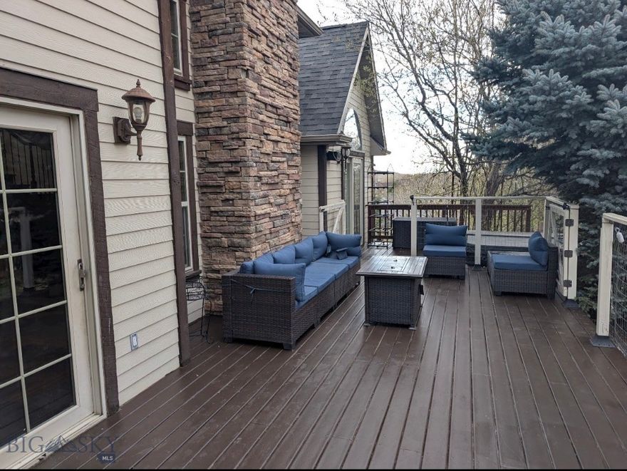 Beautifully positioned at the end of a quiet cul-de-sac, this European-inspired former Parade Home sits atop a spacious 1/3-acre lot, offering expansive views and exceptional privacy. Designed with quality and craftsmanship in mind, the home features custom concrete and hardwood floors throughout, paired  with an efficient 6-zone in-floor radiant heating system for year-round comfort.

Thoughtful custom finishes include solid wood interior doors, detailed trim work throughout, and a cozy gas fireplace that anchors the living space. The remodeled kitchen is complemented by newer stainless steel appliances, making it both stylish and functional for everyday living and entertaining.

Step outside to enjoy the large deck, perfectly positioned to take in the surrounding views. A high-end integrated audio system extends through much of the home and outdoor areas, creating an ideal setting for entertaining.

The basement has been recently updated to include private guest quarters or potential ADU, complete with a full kitchen and separate entrance, making it perfect for guests, multigenerational living, or potential rental opportunities.

Additional highlights include a new hydronic heating system with combination boiler (installed in 2017) delivering endless hot water and 95% efficiency, Corebond insulation for superior energy performance, newer roof and exterior paint, and a heated 2+ car garage.

Every detail has been thoughtfully considered in this quality custom home for the discerning buyer seeking comfort, craftsmanship, and timeless style.