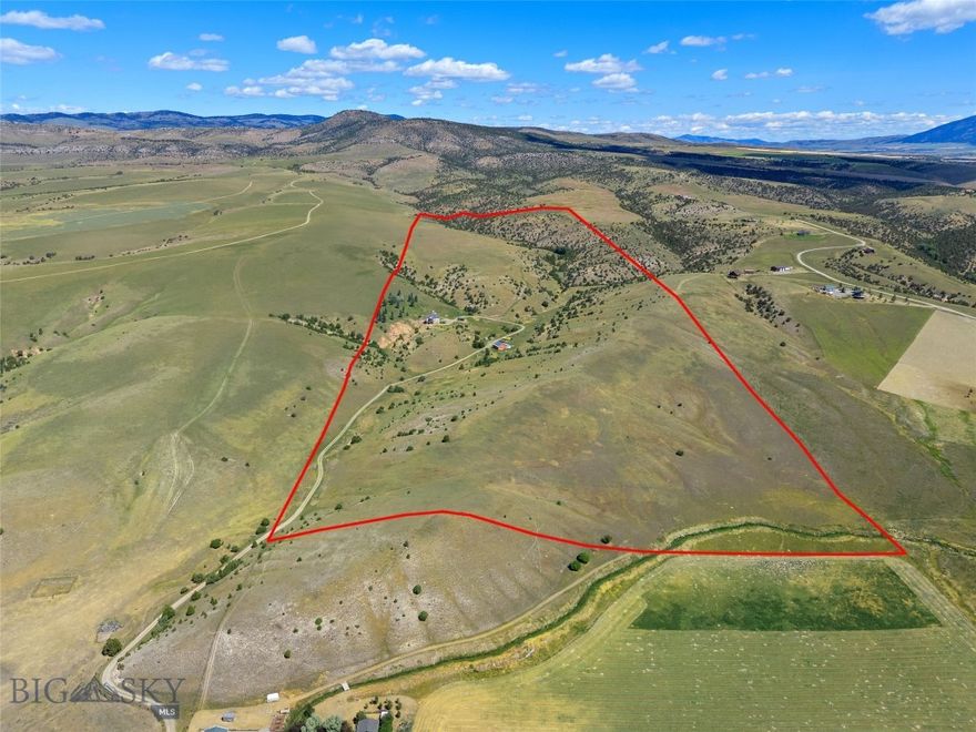 Set on 140± acres of open rangeland northwest of Belgrade, Hidden Spring Hills offers a rare chance to own a vast and unspoiled piece of the Gallatin Valley—an increasingly scarce opportunity in a region undergoing rapid development. This land is the main event: wide horizons, unobstructed mountain views, and a quiet that speaks to what Montana once was. Minimal covenants. No HOA. No commercial encroachment. Just space, sky, and possibility.
Beautiful rolling acreage with water rights (a 350 gpm irrigation well stands ready for a future owner to put water to work) and southern exposures offers pasture land for horses and livestock as well as space for all of your recreational needs– horseback riding through sunlit meadows, hiking hidden trails, sledding down snow-covered hills, cross-country skiing, or quietly observing the rhythm of wildlife in every season. Develop your own trails or follow the game trails that take you past distinctive rock outcrops, a small hidden natural spring, ravines and meadows sheltering wildlife, birds, flowers, and native grasses. 
At the heart of the parcel stands the historic Quaw Mansion– a Queen Anne landmark built in 1892 and relocated here decades ago as part of a preservation effort. The structure has been stripped to the studs and has roughed in plumbing and electrical. Its architectural bones and period details remain, waiting for a future owner to restore its legacy or reimagine its footprint. A fully finished walk-out basement provides comfortable living quarters while plans for the upper levels take shape. A detached 40'×40' shop adds valuable space for equipment, toys, or staging a renovation.
Indulge in blue-ribbon fishing on the East Gallatin River, just three minutes away, or plan an adventure into the nearby Gallatin National Forest, offering big game hunting and camping. From the homesite, take in spectacular views overlooking the East Gallatin and the rural farms and ranches that sweep outward to meet the majesty of five surrounding mountain ranges.
With its scale, privacy, water, wildlife, and storied past, this property is ideal for someone seeking solitude, long views, and a tangible connection to the valley’s heritage—before the subdivisions, before the traffic, before the sprawl. Whether preserved, rebuilt, or redefined, the land speaks for itself.
