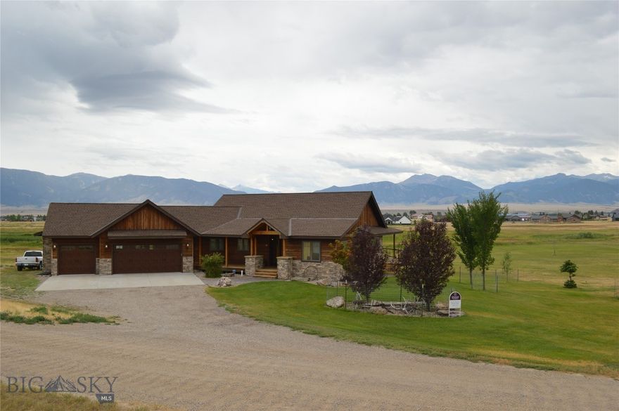 Timeless design and quality craftsmanship define this 4-bedroom, 3-bath custom home situated on 2.8 acres in the desirable Pintail Ridge Subdivision, just minutes from downtown Ennis and the Madison River.  This home offers a perfect blend of modern luxury and rustic charm, with unique features and high-end finishes throughout.  The open-concept main level includes a spacious kitchen, dining, and living area with soaring vaulted ceilings, exposed beams, and a wall of windows that frame breathtaking Madison Range views.  Sliding glass doors seamlessly connect the indoor space to the outdoors, ideal for entertaining or enjoying quiet moments.  The property borders a 31 acre common area with ponds and scenic trails, offering direct access to nature right outside your door.  The chef's kitchen is equipped with alder cabinetry, rich acacia wood flooring, concrete countertops, slate backsplash, and a breakfast bar.  The living area boasts a stunning stone (propane) fireplace, creating a warm, inviting atmosphere.  The primary suite offers private patio access, abundant natural light, a large walk-in closet, and an elegant en suite bath with natural stone and tile, a luxurious jacuzzi tub, and Moen brushed bronze fixtures.  The main level also features a second bedroom, full bath, and a generous laundry room with ample storage and access to the spacious 3 car garage.  The lower level is an entertainer's dream, with an open recreation room, two additional bedrooms, large windows, and French doors leading outside on to a stamped concrete patio.  The custom bar, crafted from local Montana white bark pine and accented with rustic corrugated tin, is perfect for hosting guests or unwinding after a long day.  The space is completed with custom-stained concrete flooring, featuring radiant heat for added comfort.  The home is a must-see, offering a wealth of distinctive and impressive amenities that combine modern luxury with mountain-inspired design.