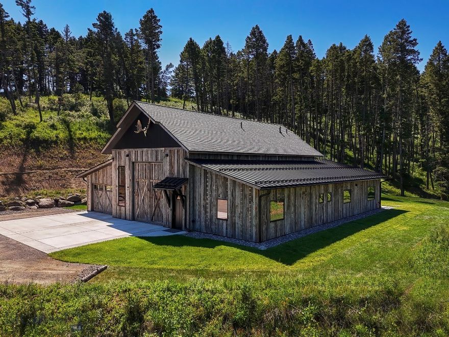 Located at the top of Elk Ridge Road, this exceptional 22.7-acre property offers a stunning mix of refined mountain living and wild Montana beauty. Built in 2023 by an experienced contractor, this custom-built luxury mountain residence with integrated shop and living quarters reflects the highest level of craftsmanship and attention to detail. Spanning approximately 3,600 square feet, the residence features a spacious, fully insulated shop with a kitchenette, two bedrooms, two full bathrooms, a well-appointed kitchen/dining/living area, and a versatile second-story flex space or office. Premium finishes include Pella windows, solid fir doors, maple cabinetry, quartzite countertops, Hunter Douglas window treatments, spray foam insulation, a level 5 wall finish, and reclaimed Montana corral board siding. A combination of 50-year shingles and a standing seam metal roof ensures long-term durability. Enjoy views of the Bridger Mountains from the timbered setting, relax in the 2024 saltwater Arctic Spa hot tub, and rest easy with a 22kW Generac generator. The property also offers access from either Elk Ridge or Cokedale Road into Livingston, creating convenient accessibility.